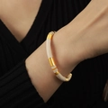 Modern gold-plated titanium steel cuff bangle in cream white and gold enamel finish - Lotus Pink