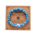 Blue beaded turtle bracelet presented on a brown Sister sentiment gift card pack - Blue White Spotted Turtle Wood Card Bracelet