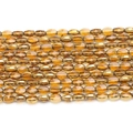 Close-up of faceted golden glass rice beads for DIY jewelry and beaded accessories - 6*8mm (Approx 36pcs/strand) / Medium Amber