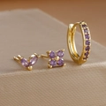 Macro shot of gold plated petal stud earrings set with purple zircon stones - Gold-Purple (3 Pcs Set)