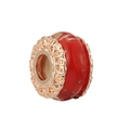 Detailed macro of red glass bead charm with golden hollow metal floral patterns - Red Round Bead Style