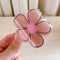 Hand holding a pink flower hair claw clip in translucent resin with black outlines - Coffee Flower-Small-6cm
