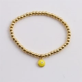 Détail du bracelet élastique doré à perles avec pendentif œil émaillé jaune - Jaune