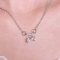 Macro shot of a silver cherry necklace with pink heart-shaped stones and white crystals - Pink Heart Cherry Choker (Z-617) / Silver