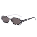 Retro oval sunglasses with black and white spotted texture frames and dark grey lenses - Black+White