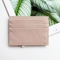 Pink genuine leather business card holder with multiple slots on a lifestyle magazine - Light Pink