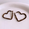 Macro view of heart-shaped leopard print earrings with soft velvet texture on white plate - Heart Shape (WE4110) / Coffee Leopard