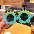 Kids funny dinosaur sunglasses with blue frame and yellow spikes for outdoor fun - Cyan Dinosaur