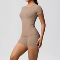 Detail showing the slim fit elastic fabric of the taupe yoga t-shirt and gym shorts set - S / Top And Bottom / Mocha Brown