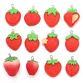 Detail view of various red resin strawberry pendants with green leaves for DIY jewelry crafts - Fixed Set of 12/32.3g