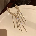 Elegant gold-tone long tassel earrings featuring sparkling leaf-shaped crystal studs - Gold Curved Leaf Tassel (144)