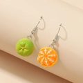 Detail shot of creative orange fruit earrings featuring textured green and citrus segments - Yellow And Green Combination