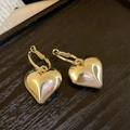 Close-up of golden heart hoop earrings on dark wood surface showing polished texture - 27# Gold Heart Hoop Pendant Style (27# Silver Earring Post-Gold-Heart)