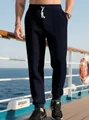 Detail of navy waffle knit joggers featuring white drawstring and elastic waistband - Navy Blue