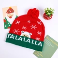 Detailed view of red knitted Christmas LED hat featuring FA-LA-LA-LA text and snowflake patterns - Red Green FA-LA-LA Snowflakes