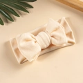 Detailed texture of beige knit baby headband with a large double-layer bow design - Off White