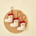 Three red and white felt Christmas stocking ornaments with snowflake embroidery on a mat - White Socks (3 Pcs/Pack)