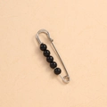 Silver metal waist pin with five round black pearls on a textured beige paper background - 6.5cm 5 Black Beads Silver