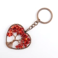 Detailed view of handmade heart-shaped Tree of Life keychain with red natural crystal stones - Red Coral
