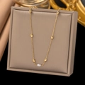 Elegant gold necklace with oval beads and white pearl on a jewelry box lid - Seed Bead Chain Necklace / Gold
