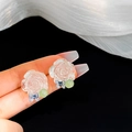 Floral stud earrings featuring translucent resin rose, green bead, and blue butterfly - Translucent Rose Butterfly Studs