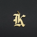 Gothic font letter K gold pendant accessory shown on a dark textured background - Letter K
