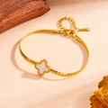 Detail of gold curb chain clover bracelet with white mother of pearl inlay on beige texture - White Shell Four-Leaf Clover (M710)
