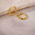 Elegant round golden hoop earrings with high polish finish on a natural stone surface - Inner Diameter 12mm / Gold