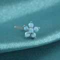 Macro shot of silver flower nose stud with blue stones on teal silk fabric background - Style A / Blue Turquoise
