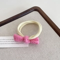 Pink corduroy bow hair tie with high elastic yellow band on a wooden tray - Red and Yellow
