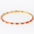 Close-up of gold plated tennis bracelet with orange rectangular and white round zircons - Orange Zircon Gold