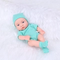 Reborn baby doll in green polka dot romper and matching hat on soft white plush surface - Emerald Green Polka Dot