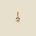 Golden teardrop pendant necklace featuring a clear zircon stone on a beige background - Teardrop Pendant