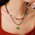 Close-up of layered Christmas necklaces with glass seed beads and a festive tree pendant - D1235 Double Layer Christmas Tree Pendant