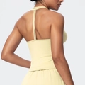 Detail of light yellow yoga sports bra showing slim crisscross back straps and soft fabric - Light Yellow