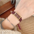 Elegant rectangle watch with burgundy leather strap and gold case worn by a model - Rectangular Case