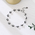 Detailed view of evil eye bracelet with black beads and adjustable silver chain link - Black Eyes Silver