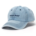 Detail of blue denim baseball cap showing premium embroidery and stitching on the curved brim - Denim Blue
