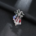 Close-up of Christmas bell brooch with colorful enamel and sparkling rhinestones - Silver Christmas Bell