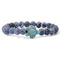 Blue beaded bracelet with turquoise turtle charm on a minimalist white background - Black Weathered Agate