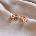Close-up of gold earrings with pink enamel flowers, crystal butterflies on soft cloth - Gold Pink Enamel Flower Butterfly Style (HE18721)