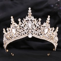 Detailed close-up of golden bridal tiara with sparkling crystal leaves and rhinestones - KC Gold With White Rhinestone