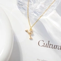 Detailed view of a gold 'Y' letter pendant with clover zircon on a minimalist chain - Letter Y