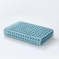 Light blue cotton waffle weave face towel in a three-fold presentation style - 34x34cm / Blue