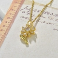 Detail of sunflower pendant with cubic zirconia on gold chain with vintage props - Sunflower Necklace / White