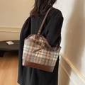 Blue and brown tweed tote bag with leather straps worn by a model in a black coat - Blue Plaid