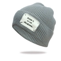 Dark grey knitted beanie with vintage label patch and ribbed texture on white background - One Size / Light Gray