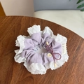 Detail of lavender scrunchie with white lace trim, button accent, and logo label - Solid Purple - White Lace Tie Bow Scrunchie