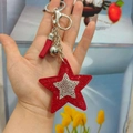 Sparkling red rhinestone star keychain with silver accents and matching tassel charm - Red