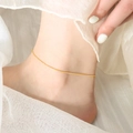 Minimalist 18K gold plated thin snake bone anklet for women on a white background - 21+5cm / Gold